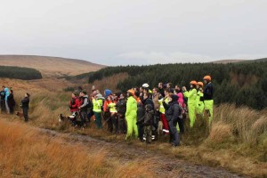 Crowd watches Irish Coast Guard Helicopter take off from the Three Dunes, Clogheen
